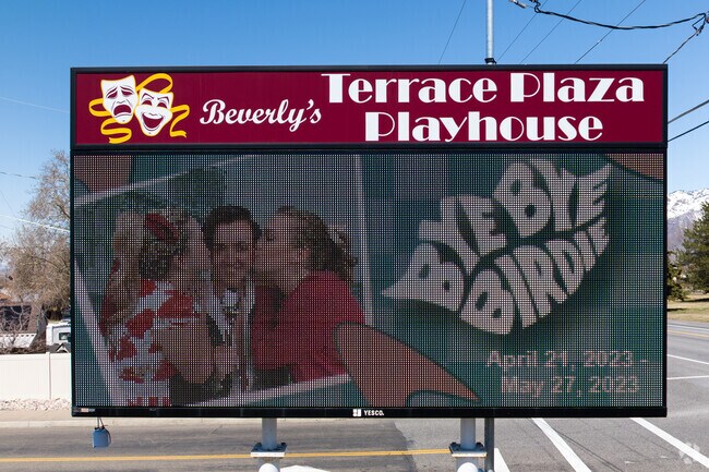 An advertising billboard for Beverly's Terrace Plaza Playhouse stands near Highway 89.