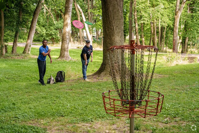 Disc golfers get some practice in while waiting for their friends at Bayard Square's Canby Park.
