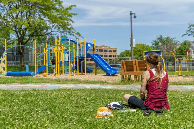 A Merrill Park resident waitches over their little ones at the neighborhood park.