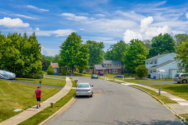 A man enjoying a stroll through Aston Township neighborhood on a sunny day.