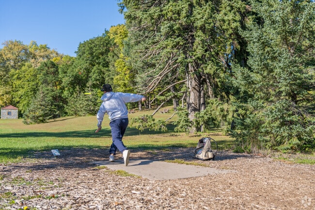 A Disc Golfer teeing off on a 18 hole course adjacent to Highland Park National Golf Course.