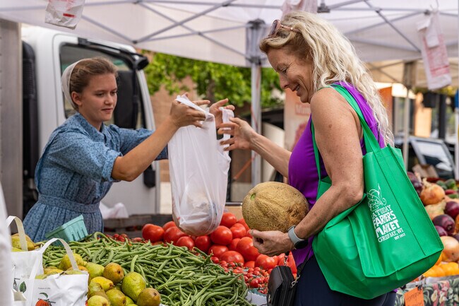 Local producers sell fresh fruits and vegetables at Saturday Farmer's Market in Downtown.