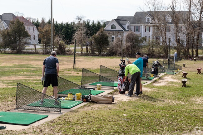 Practicing before the game at Mellomar Golf Park driving range in Owings, Maryland.