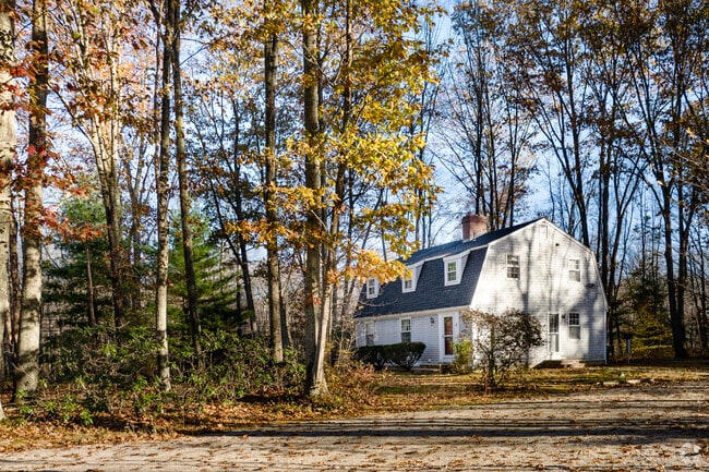 Contemporary cottages are tucked among wooded landscapes in Scituate, Rhode Island.