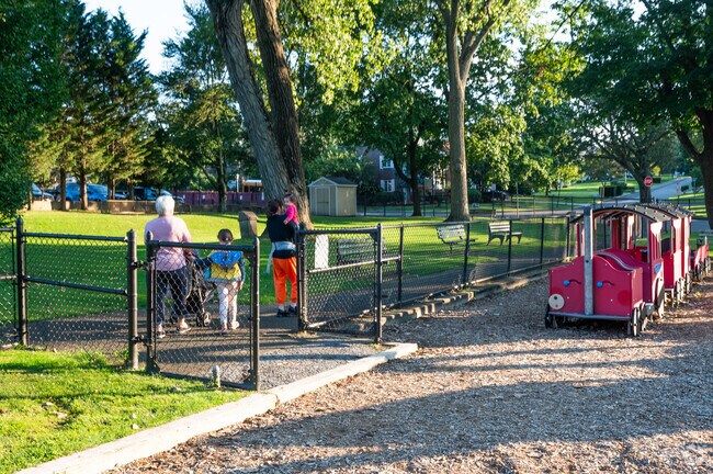 Families gather at Upland Park in Lake Success for play and relaxation.