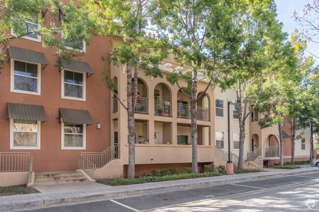 Three-story townhomes and tree-lined streets encompass a block in Hillsdale.