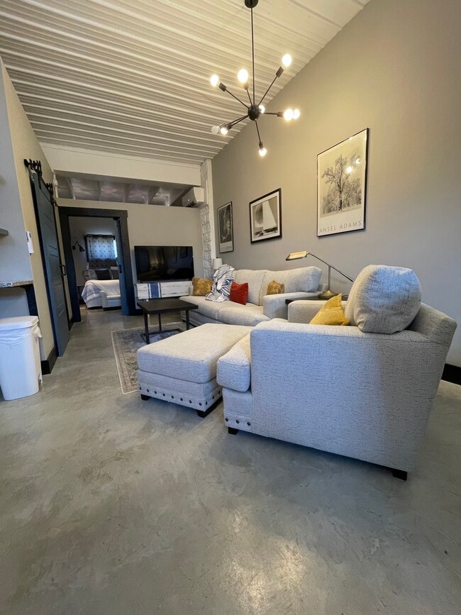 Couch, and chair-and-a half in living room, smart tv.