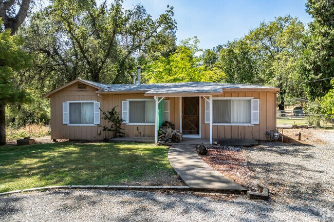 This manufactured home is on its own lot in the trees of Mountain Gate.