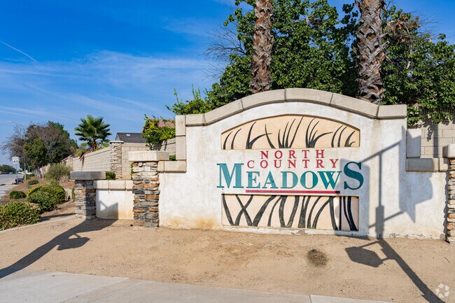 A beautiful stone and plaster sign outside the homes of North Country Meadows.