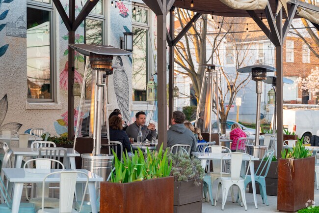 Residents enjoying the outdoor seating at Pennyroyal Station in Mount Rainier.