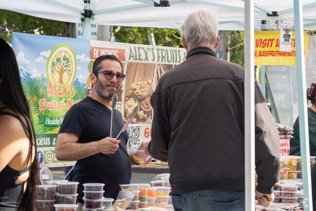 Alex the happy fruit and nut vendor shares his products at the Redlands Farmers' Market.