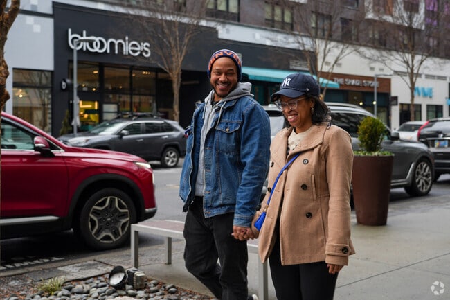 A couple walks together through the Mosaic District.