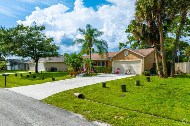 Colorful homes offering manicured lawns in Northport Village.