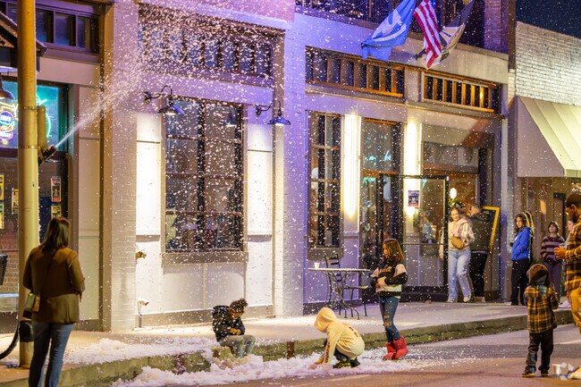 Let kids enjoy playing in the festive fake snow at the Downtown Holiday Stroll.