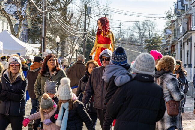 The Fire Queen stands high above the crowd on her stilts at the Fire and Ice Festival near Vistas.