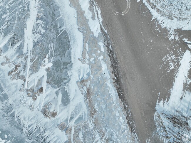 Ice on Ashtabula's Lake Erie shore meets the sand, where summer beach goers soak up the sun.