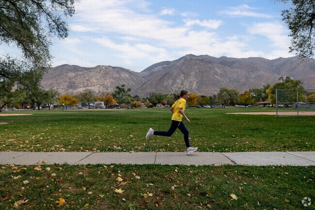 A young runner enjoys the outdoors at Monroe Park.