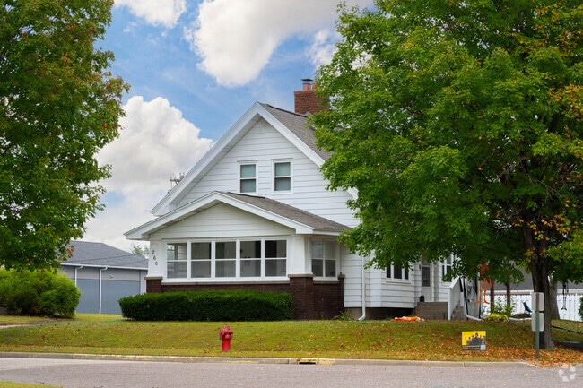 Single-family homes sit on a shaded lots in a Mondovi neighborhood.