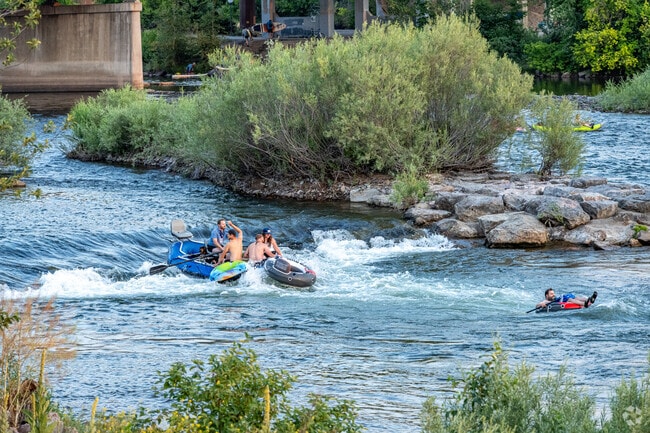 Enjoy river surfing on the Clark Fork River's serene waters.