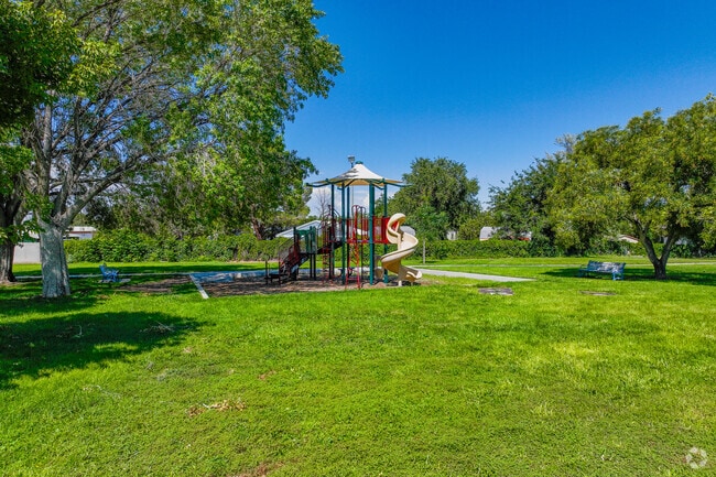 Jade Park offers a shaded playground beneath mature trees.