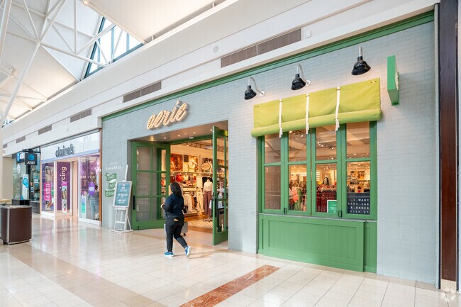 Woodlands Mall visitors navigate its vibrant retail hub near Security.