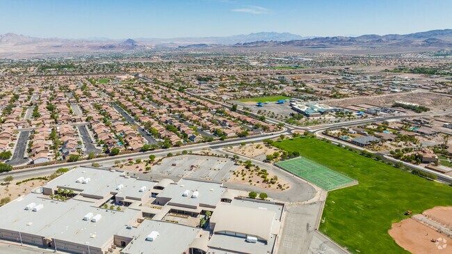 Aerial shot of the school, houses nearby, and James E & A Rae Smalley Elementary School in the distance (right).