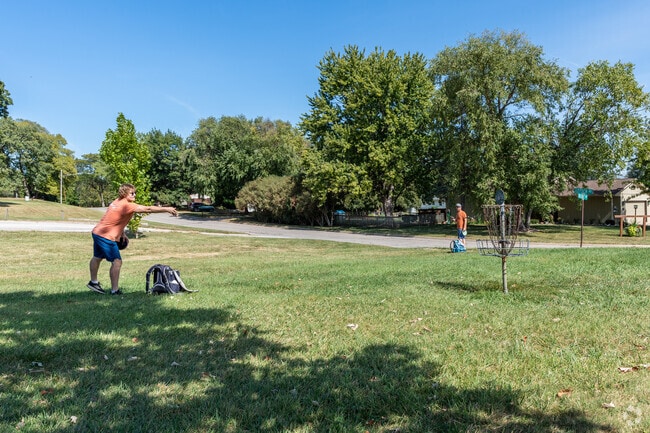 Friends play a game of disc golf at Valley View Park.