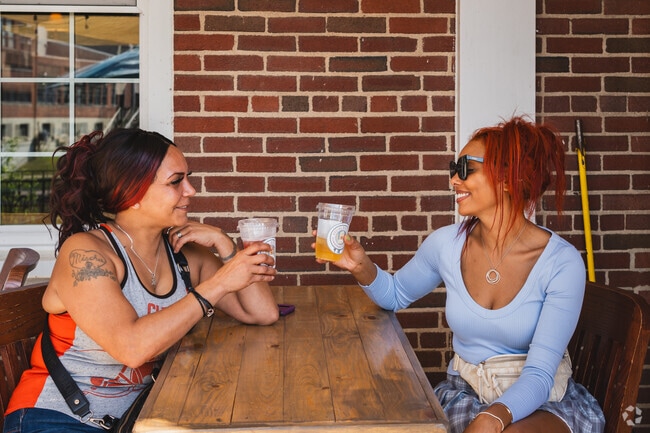 These ladies appreciate the good life at Michigan Wine and Beer Portal along the River Raisin.