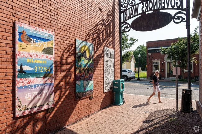 The late afternoon sun casts long shadows along Governors’ Walk in Milton.