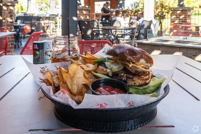 The Village Squire Restaurant serves chips with a chicken sandwich near St. Charles, IL.
