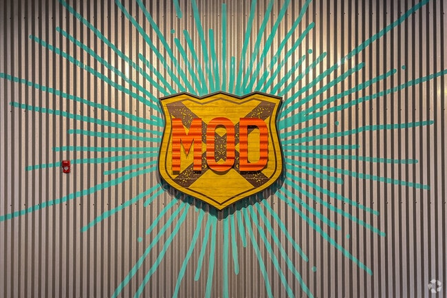 Diners create their own pizza at MOD Pizza near the Temple neighborhood.