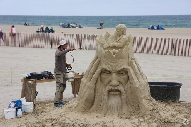 Artist secure their creations at the Hampton Beach Sand Sculpting Classic.