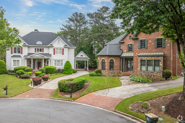 This stately brick colonial-style home in Mountaire Springs showcases traditional design and a beautifully landscaped front yard.