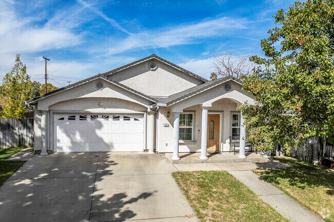 This newer upgraded ranch-style home has stucco siding in Strawberry Manor.