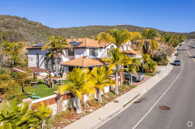 A view of Spanish style homes under palm trees in Rancho Peñasquitos.