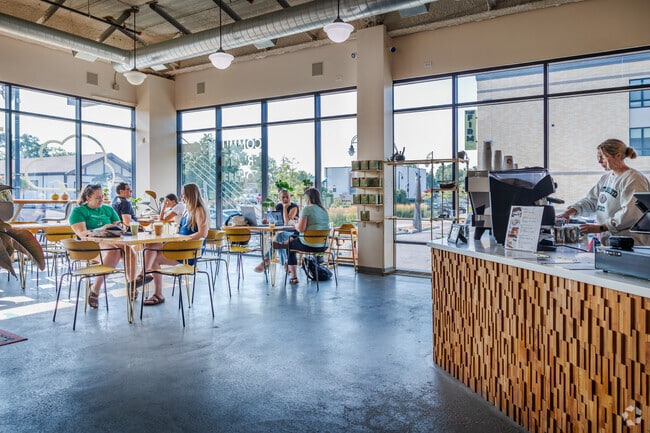 Residents enjoy the spacious, naturally lit interior of Thunder Coffee near Berger.