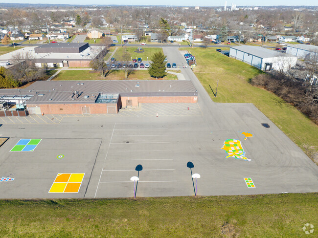 Many kids play basketball with their friends on the court.