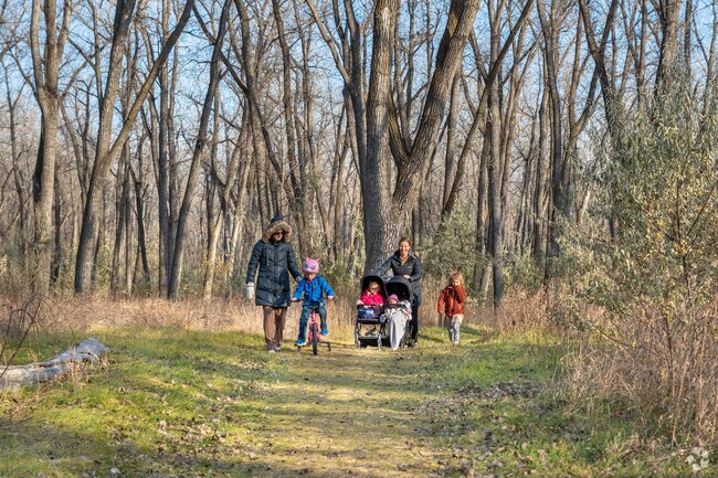 Families enjoy hiking the forested trails at Atkinson Nature Park.