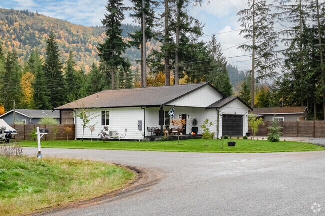 Many homes in the Maple Falls area are shaded and surrounded by fir and cedar trees.