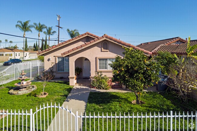 A small home in Hawaiian Gardens with a fountain and fruit tree.