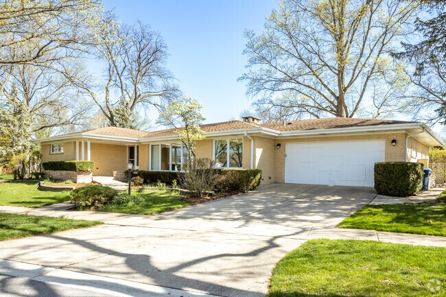Yellow Brick Ranch-Style Homes With Attached Garage and Minimal Landscaping Located in Springdale.