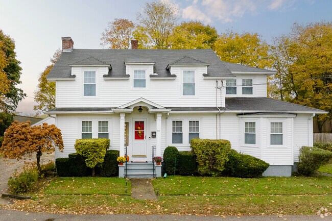 Elegant estates in Natick feature spacious lawns decorated with old trees.