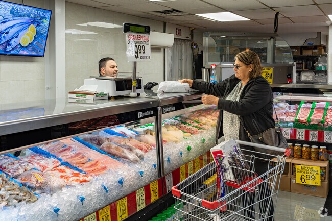 A Farmersville mom picks up some fresh fish at Mercado Sol Del Valle.
