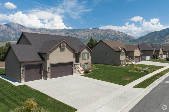 This charming home painted in creamy beige and off whites has a beautifully landscaped yard.