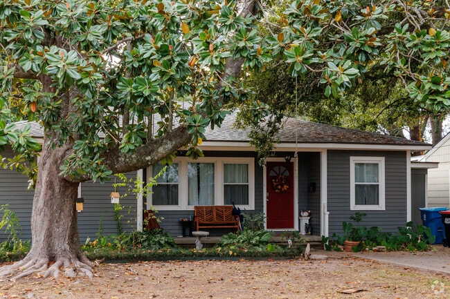 Cottages with colorful doors and magnolia trees adds curb appeal in Saints Streets.