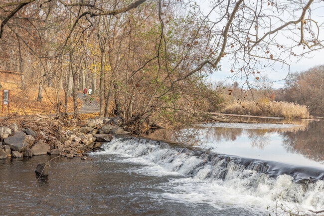 The Bronx River streams around the park and visitors can walk along its shores.