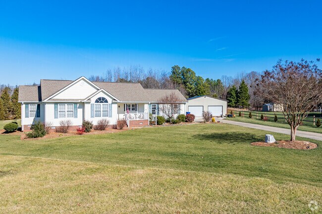 In Climax, a modern Ranch style home is showcased on a well-manicured lawn.