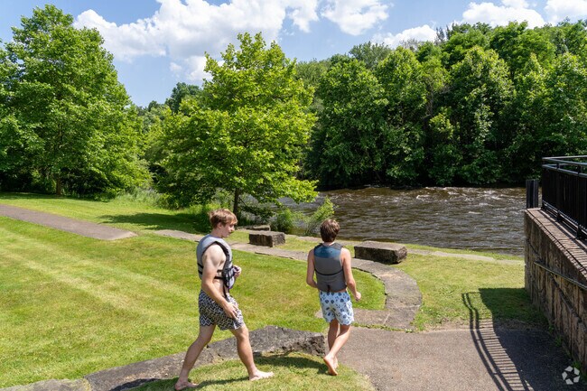 On a hot day, residents of Munroe Falls prepare to cool off in the Cuyahoga River at Brust Park.