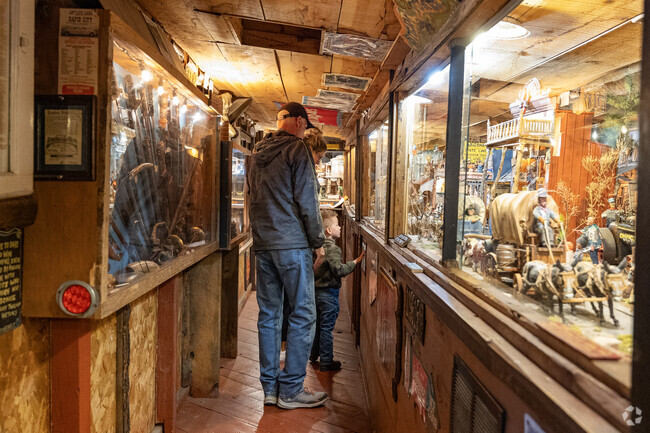 A family enjoys browsing the Tinkertown Museum near Thunder Mountain.