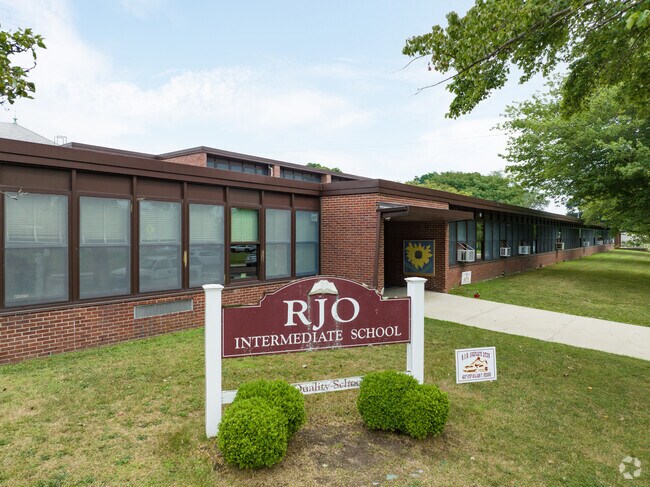RJ O Intermediate School's main entrance has artwork near the doors.